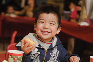 A little boy smiling while holding a bread roll. Links to Gifts by Will A little boy smiling while holding a bread roll. Links to Gifts by Will
