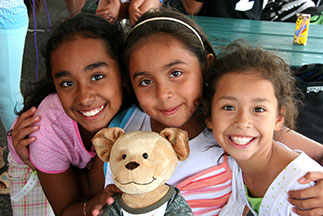 Three girls smiling with a stuffed dog toy. Links to Gifts by Estate Note Three girls smiling with a stuffed dog toy. Links to Gifts by Estate Note