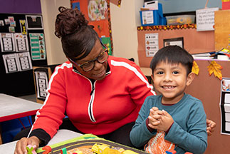 A woman helping a boy. Links to Gifts That Pay You Income A woman helping a boy. Links to Gifts That Pay You Income