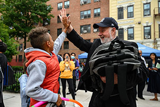 A man giving a boy a high five. Links to What to Give A man giving a boy a high five. Links to What to Give