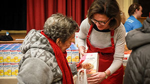 Photo of volunteer giving to another